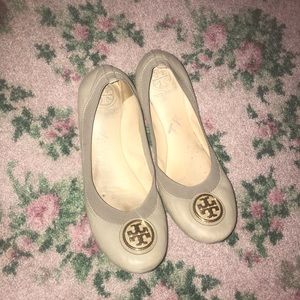 Tan colored Tory Burch flats with gold logo